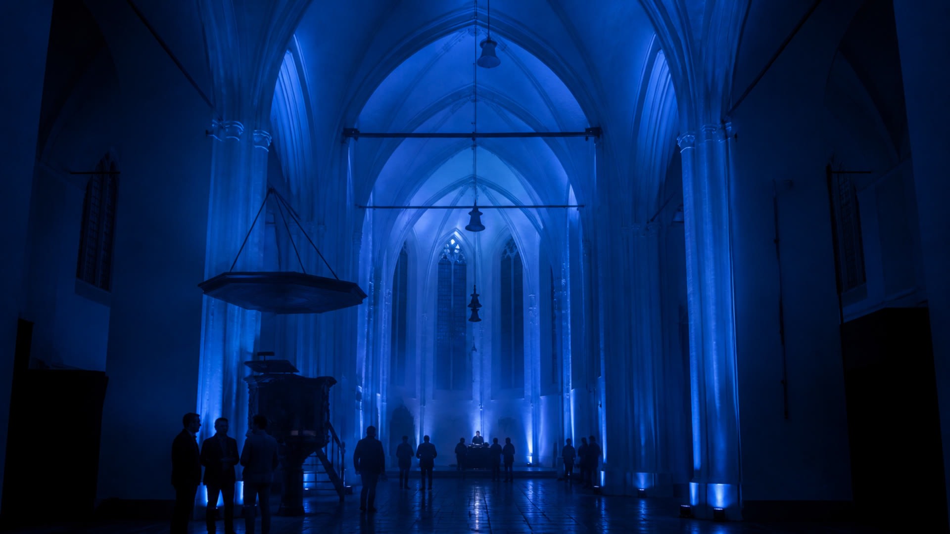 The frozen vessel. The church held still and blue, before anything moves.